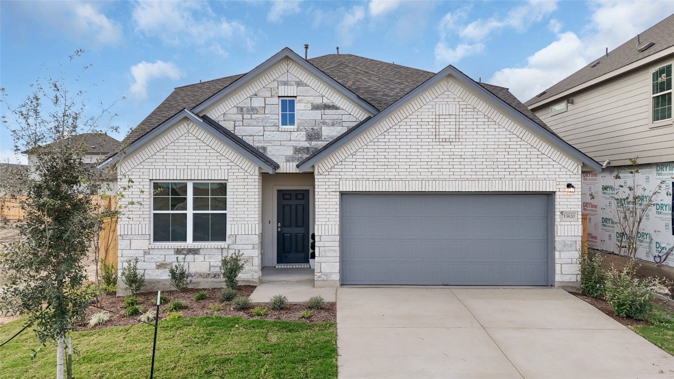 25624 Wheat Seed Lane Elgin, TX 78621 - Photo 13 of 40 a front view of a house with a yard and garage