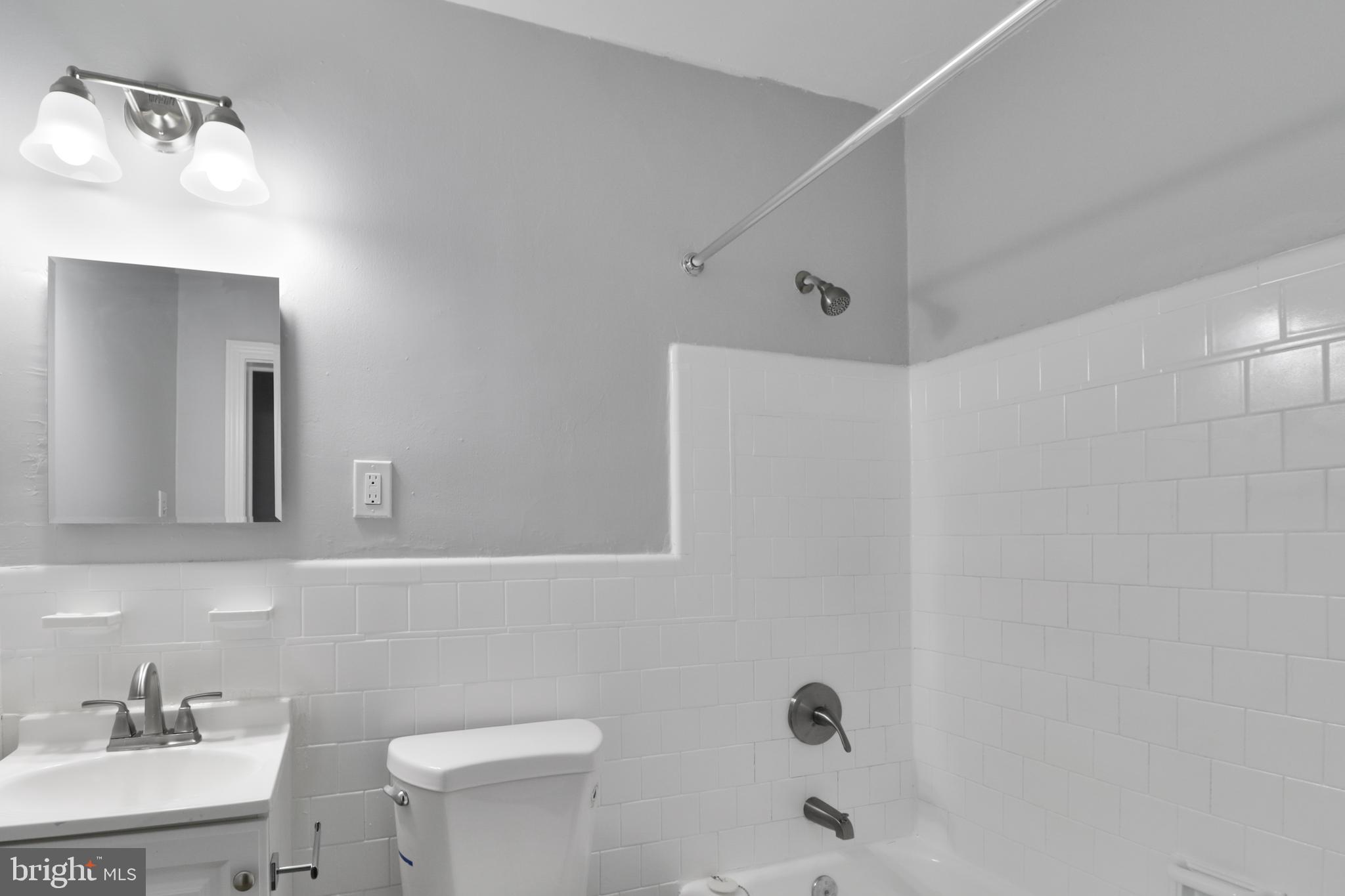 6151 Chinquapin Parkway Baltimore, MD 21239 - Photo 20 of 22 a bathroom with a sink a toilet and shower