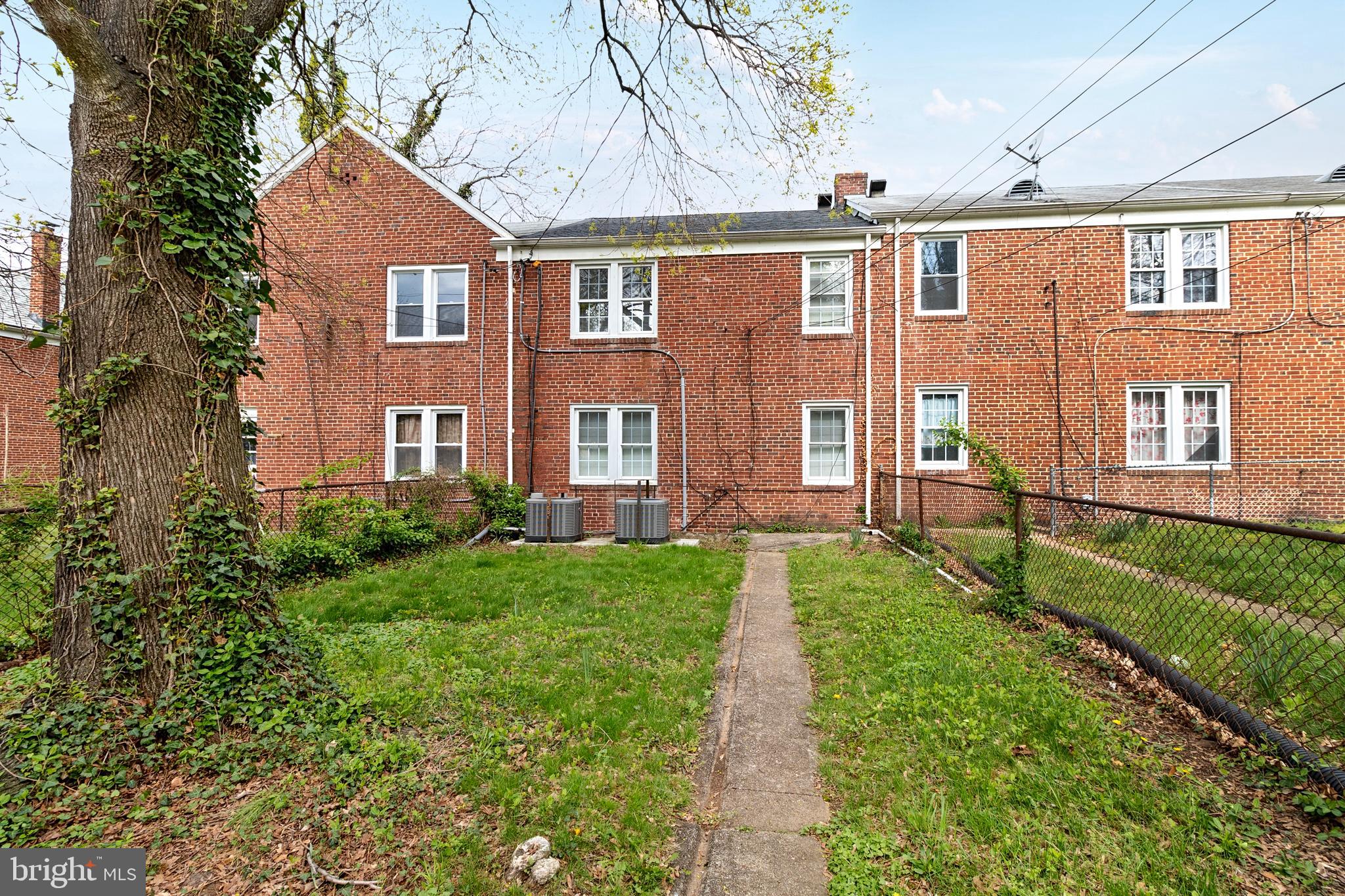 6151 Chinquapin Parkway Baltimore, MD 21239 - Photo 22 of 22 a front view of a house with a yard