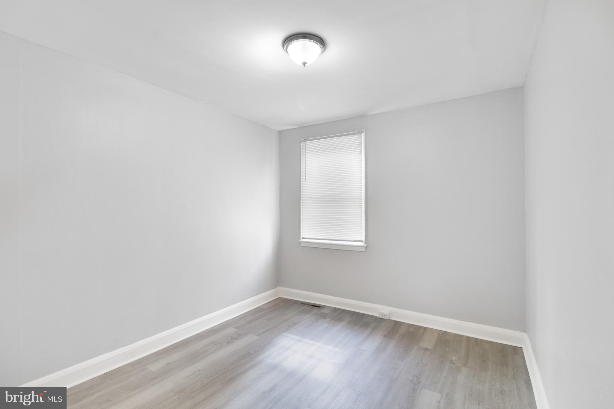 6151 Chinquapin Parkway Baltimore, MD 21239 - Photo 8 of 22 an empty room with a window