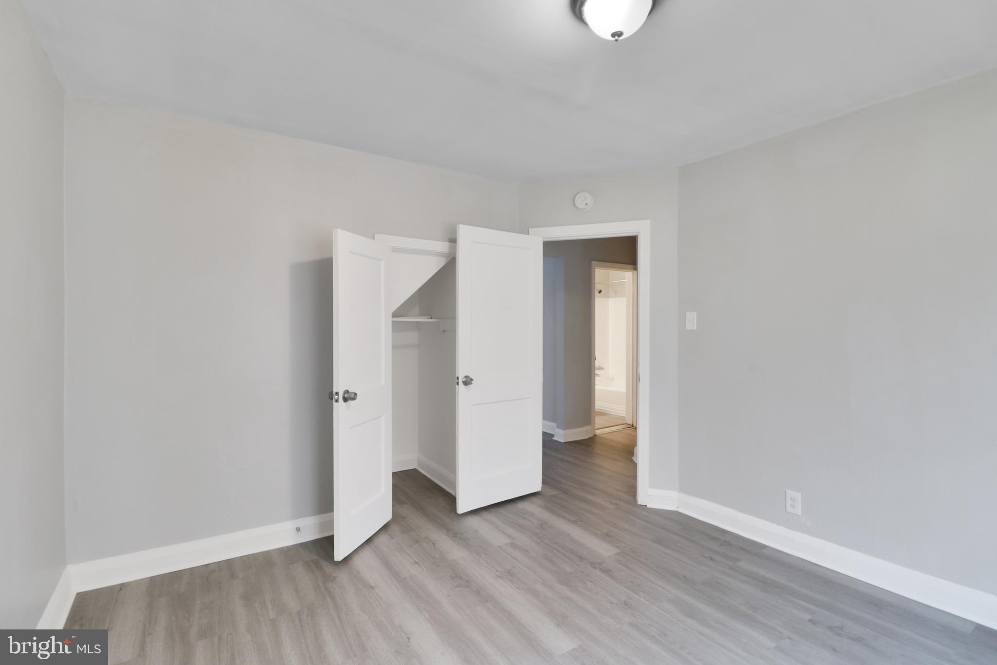 6151 Chinquapin Parkway Baltimore, MD 21239 - Photo 10 of 22 a view of an empty room with wooden floor