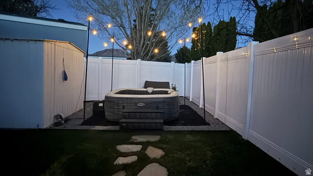 502 West 725 North Logan, UT 84321 - Photo 25 of 25 Fenced backyard featuring a patio and a storage unit