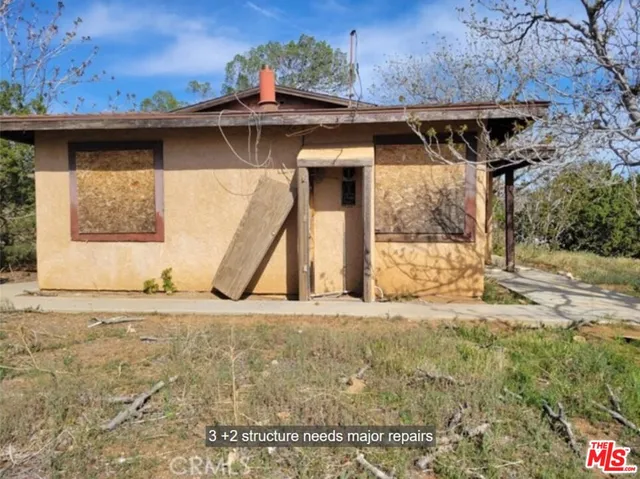 a view of a house with a wooden deck
