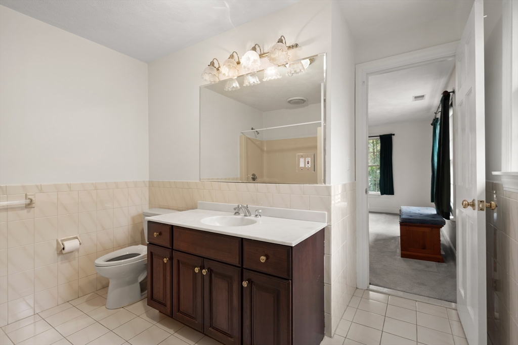 37 Old Planters Road Beverly, MA 01915 - Photo 29 of 42 a bathroom with a sink a toilet a mirror and vanity
