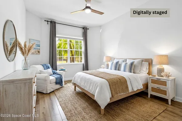 a very nice looking open kitchen with stainless steel appliances granite countertop a stove a refrigerator a dining table and chairs with wooden floor