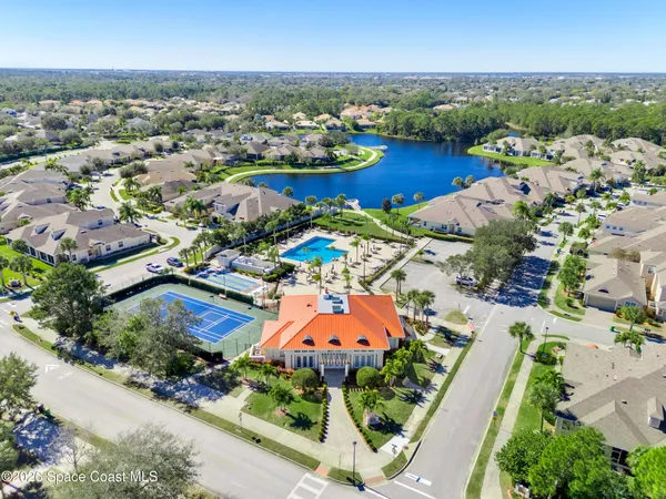 a living room with furniture a flat screen tv and wooden floor