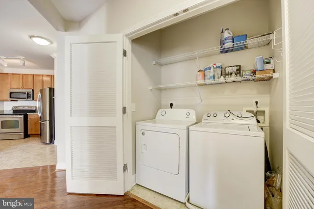 a view of washer and dryer with kitchen in the background