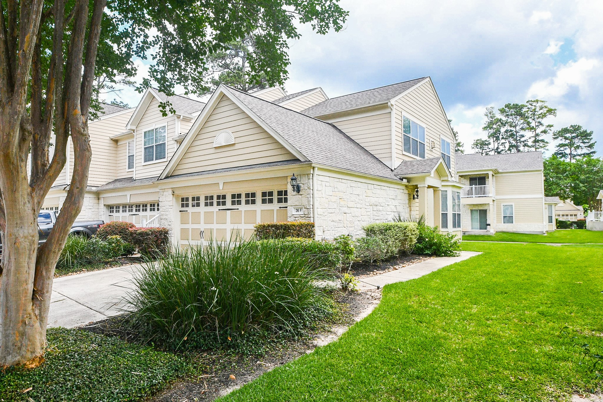 13600 Breton Ridge Street, Unit 36F Houston, TX 77070 - Photo 6 of 38 Beautifully maintained exterior with greenery.