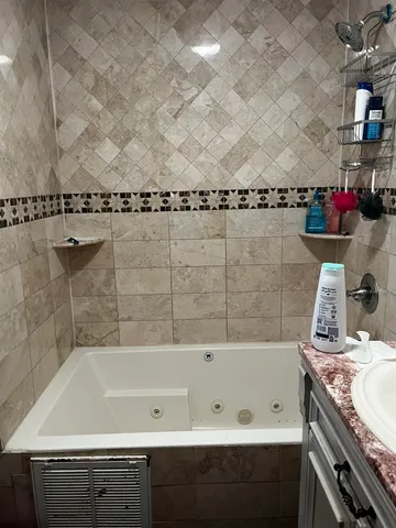 a bathroom with a bathtub and a sink