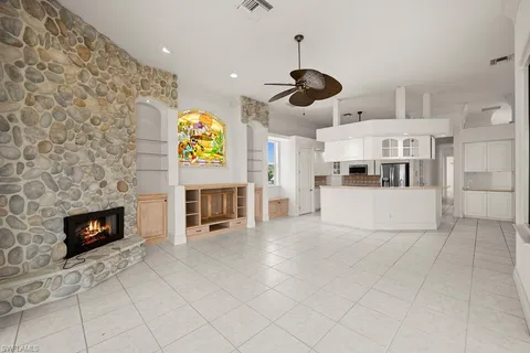a kitchen with stainless steel appliances granite countertop a fireplace cabinets and a counter top space