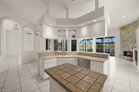 a large white kitchen with a sink and cabinets