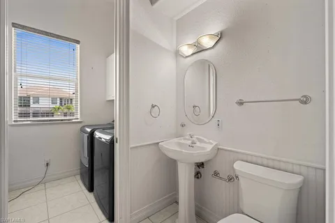 an aerial view of a city with ocean view in back