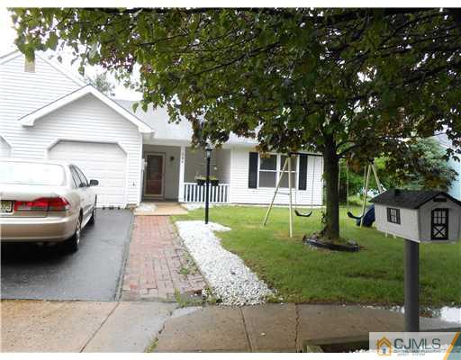 151 Woodbury Road Edison, NJ 08820 - Photo 1 of 15 a view of a white house next to a yard with big trees
