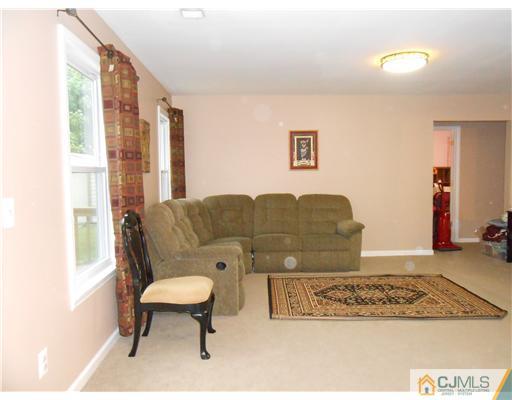 151 Woodbury Road Edison, NJ 08820 - Photo 2 of 15 a living room with furniture and a rug