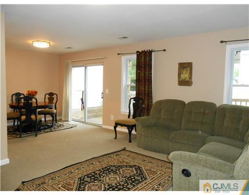 151 Woodbury Road Edison, NJ 08820 - Photo 11 of 15 a living room with furniture and a large window