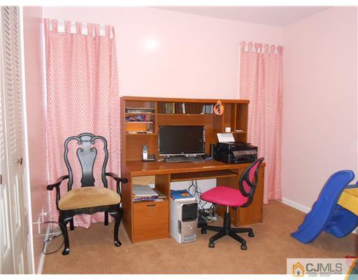 151 Woodbury Road Edison, NJ 08820 - Photo 14 of 15 a living room with furniture a rug and a chair