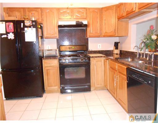 151 Woodbury Road Edison, NJ 08820 - Photo 4 of 15 a kitchen with stainless steel appliances granite countertop a stove a refrigerator and a microwave