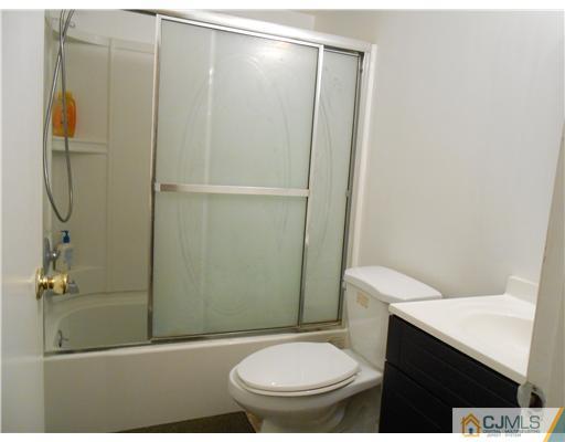 151 Woodbury Road Edison, NJ 08820 - Photo 7 of 15 a bathroom with a toilet and a shower