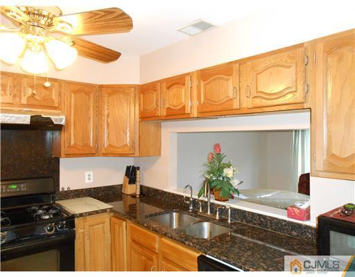 151 Woodbury Road Edison, NJ 08820 - Photo 10 of 15 a kitchen with sink and cabinets