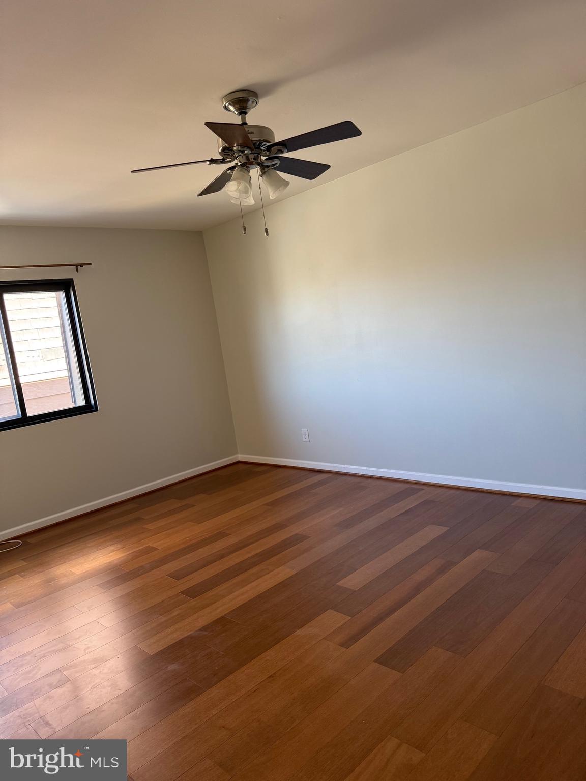 12702 Veirs Mill Road, Unit 51301 Rockville, MD 20853 - Photo 13 of 26 an empty room with wooden floor fan and windows