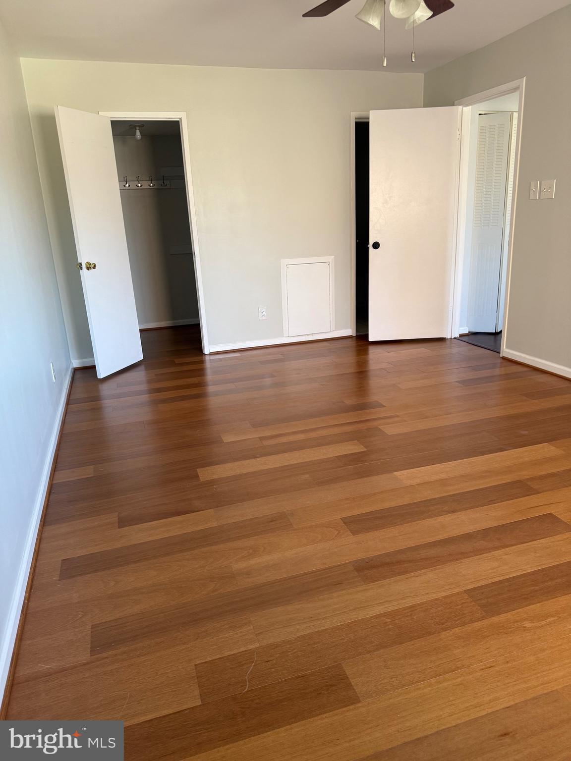 12702 Veirs Mill Road, Unit 51301 Rockville, MD 20853 - Photo 14 of 26 a view of a hallway with wooden floor
