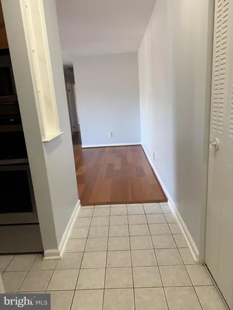 a kitchen with stainless steel appliances a refrigerator a sink a stove top oven and wooden floor