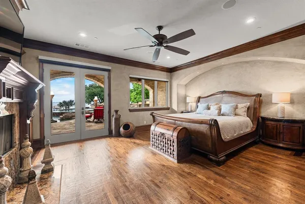 a bedroom with a large bed and a chandelier
