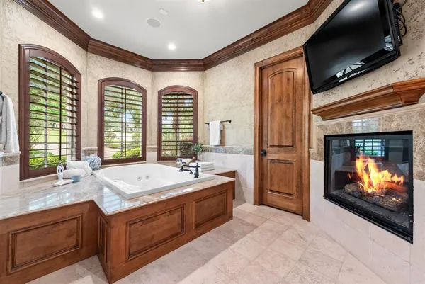 a bathroom with a sink a bathtub and a large mirror