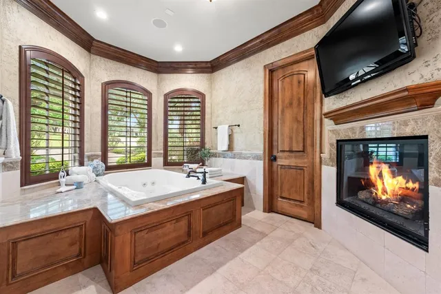 a bathroom with a sink a bathtub and a large mirror