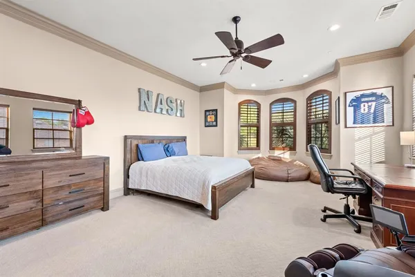 a bedroom with a large bed and windows