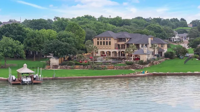 a aerial view of a house with a yard and lake view