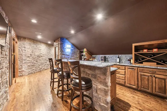 a kitchen with stainless steel appliances kitchen island granite countertop a sink and cabinets