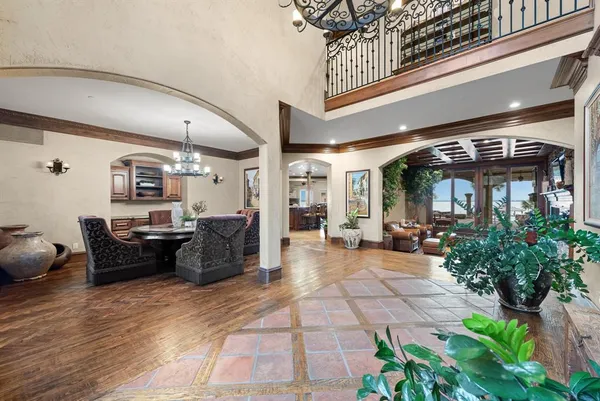 a living room with furniture and potted plants