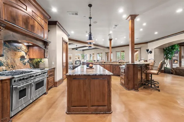 a kitchen with stainless steel appliances granite countertop a stove and a refrigerator