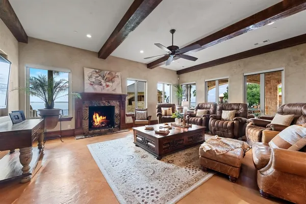 a living room with furniture a fireplace and a large window