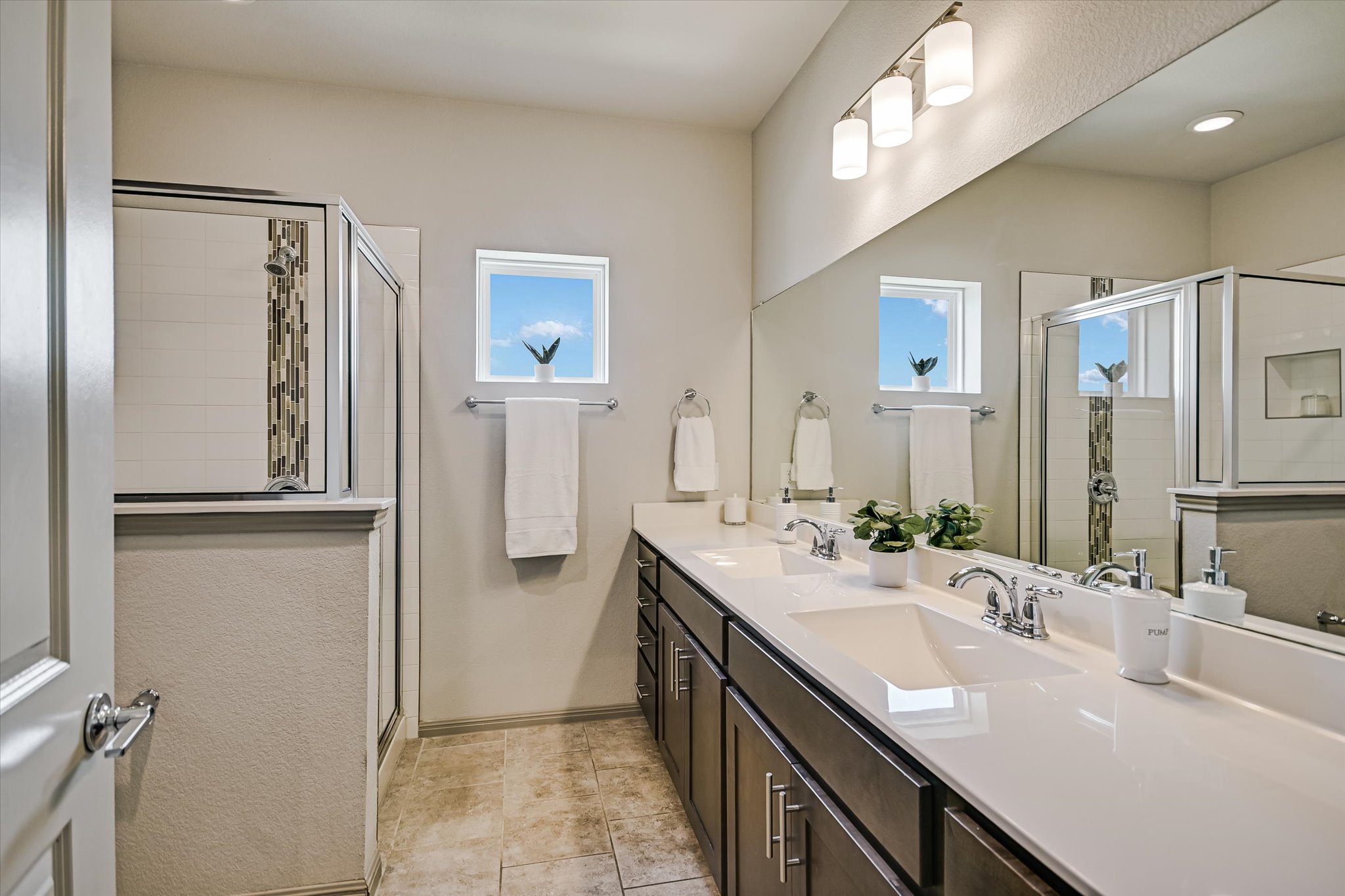 5613 Charles Merle Dr. Austin, TX 78747 - Photo 14 of 34 a bathroom with a double vanity sink mirror and double