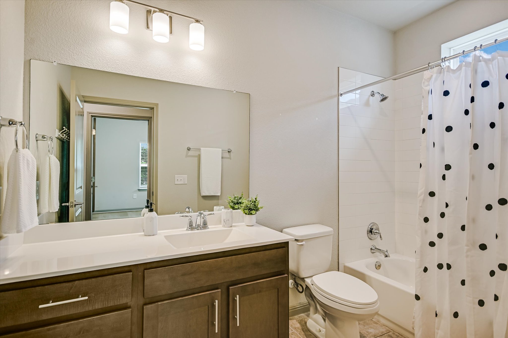 5613 Charles Merle Dr. Austin, TX 78747 - Photo 16 of 34 a bathroom with a sink a toilet a shower and a mirror