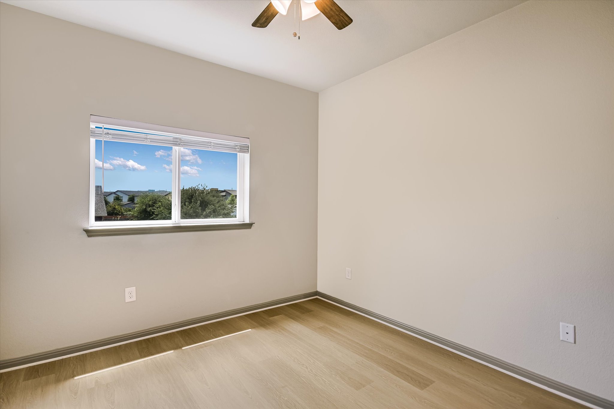 5613 Charles Merle Dr. Austin, TX 78747 - Photo 17 of 34 an empty room with a window and a ceiling fan