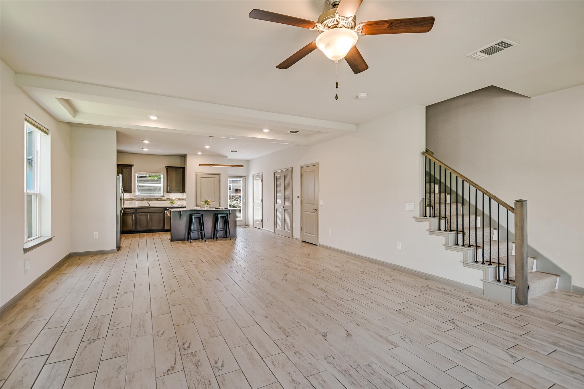 5613 Charles Merle Dr. Austin, TX 78747 - Photo 34 of 34 a view of an empty room with wooden floor and a ceiling fan