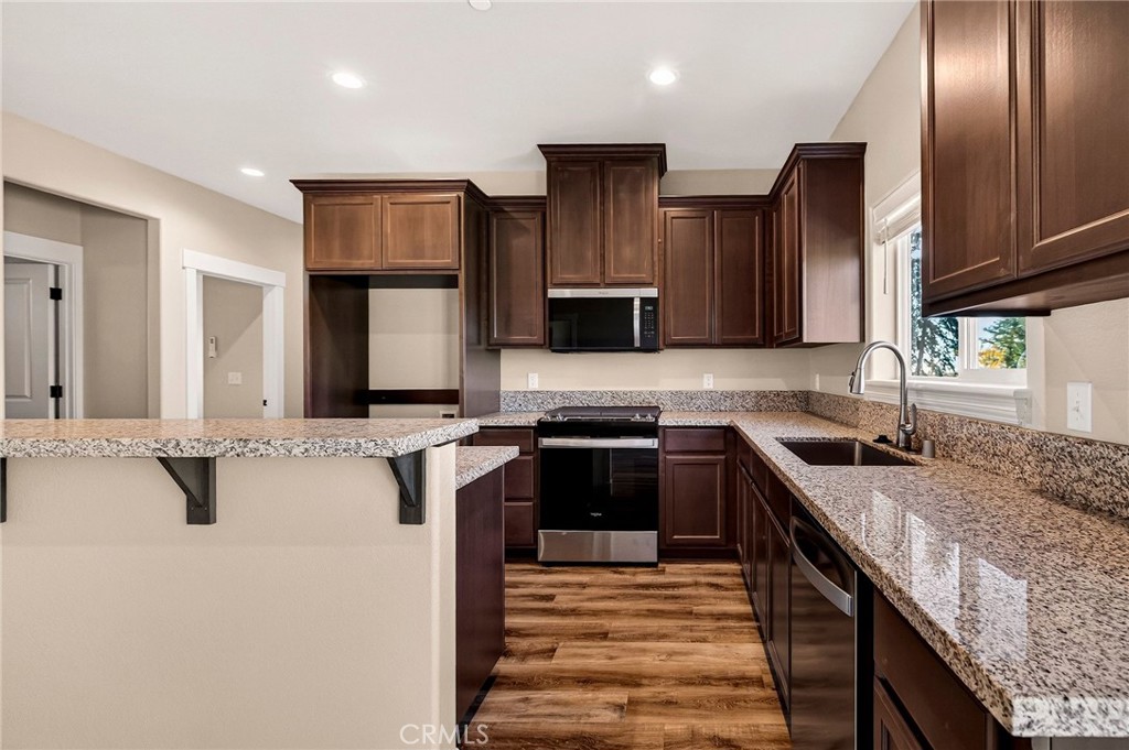 7083 Pentz Road Paradise, CA 95969 - Photo 12 of 46 a kitchen with stainless steel appliances granite countertop a sink stove and refrigerator