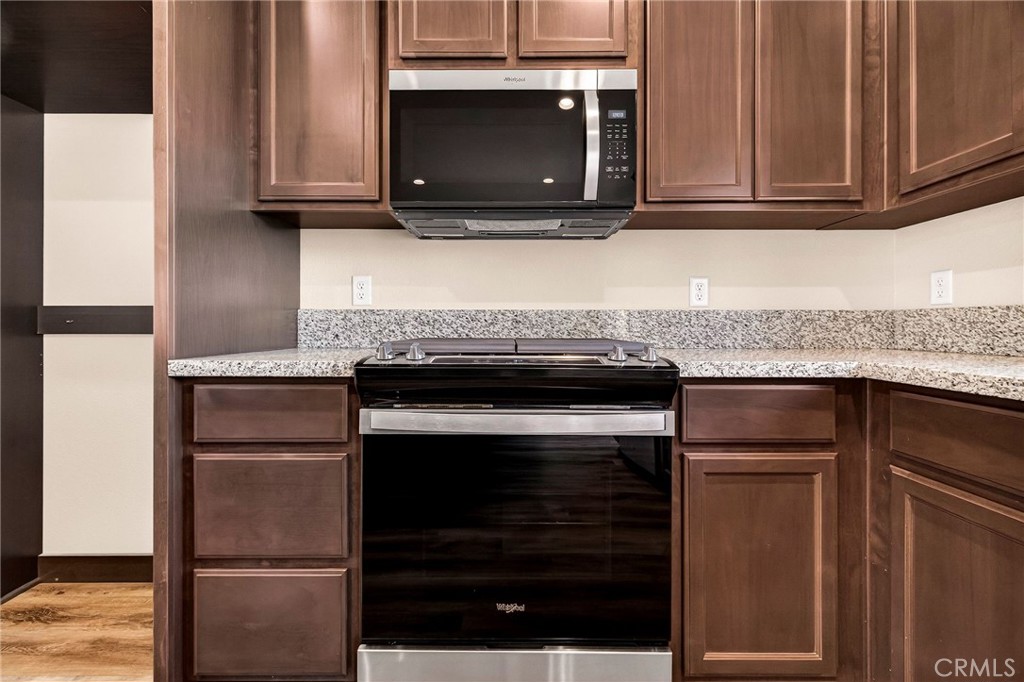 7083 Pentz Road Paradise, CA 95969 - Photo 15 of 46 a kitchen with granite countertop cabinets stainless steel appliances and wooden cabinets