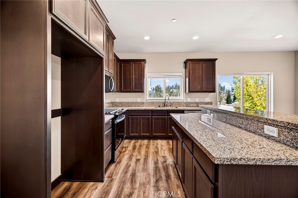 7083 Pentz Road Paradise, CA 95969 - Photo 16 of 46 a kitchen with stainless steel appliances granite countertop a sink stove and refrigerator