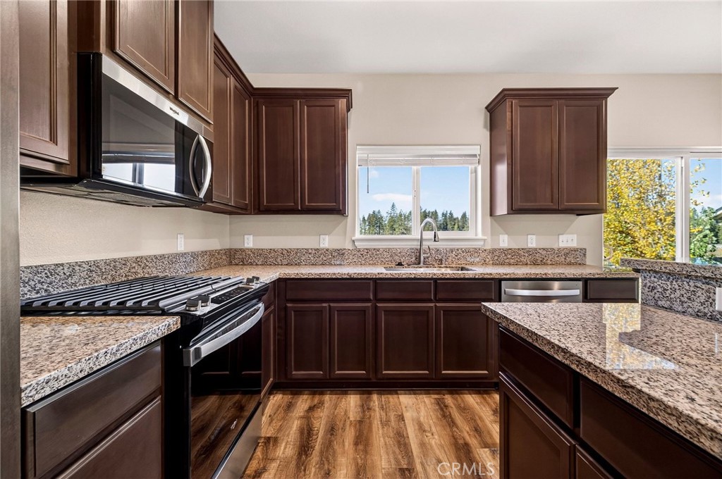 7083 Pentz Road Paradise, CA 95969 - Photo 17 of 46 a kitchen with granite countertop a sink a stove and cabinets