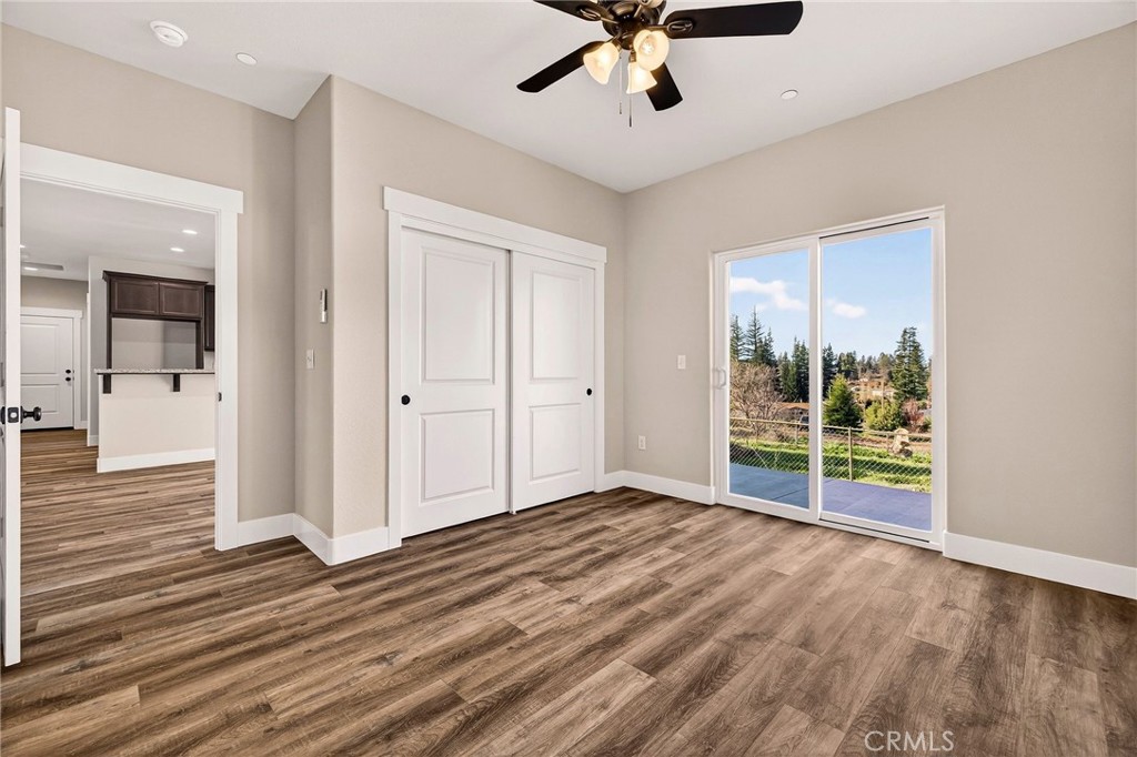 7083 Pentz Road Paradise, CA 95969 - Photo 24 of 46 an empty room with wooden floor and windows