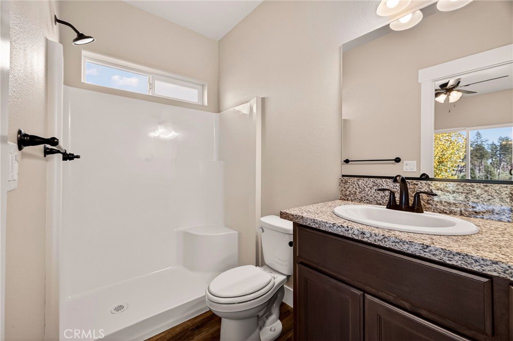 7083 Pentz Road Paradise, CA 95969 - Photo 26 of 46 a bathroom with a granite countertop sink toilet and shower