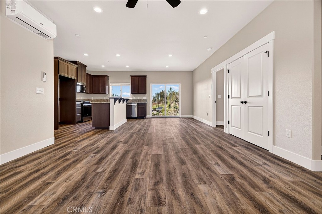 7083 Pentz Road Paradise, CA 95969 - Photo 9 of 46 a open kitchen with stainless steel appliances granite countertop a refrigerator oven a sink dishwasher and white cabinets with wooden floor