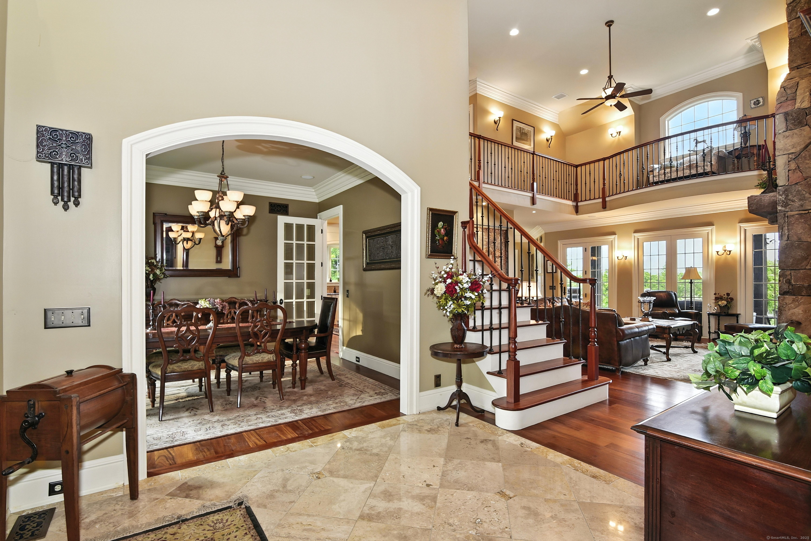 282 Searles Road Pomfret, CT 06259 - Photo 24 of 40 Stunning view from the atrium: Formal dining room through the eyebrow arched doorway, staircase, great room, and upper balcony.