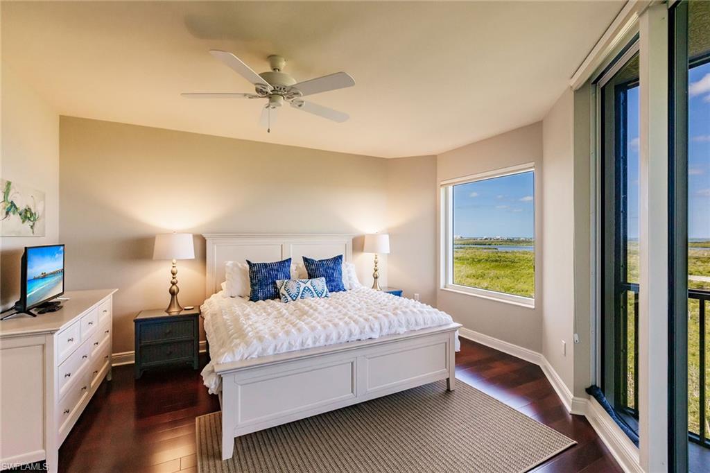 1065 Borghese Lane, Unit 1003 Naples, FL 34114 - Photo 13 of 43 a bedroom with a bed and a tv on the dresser