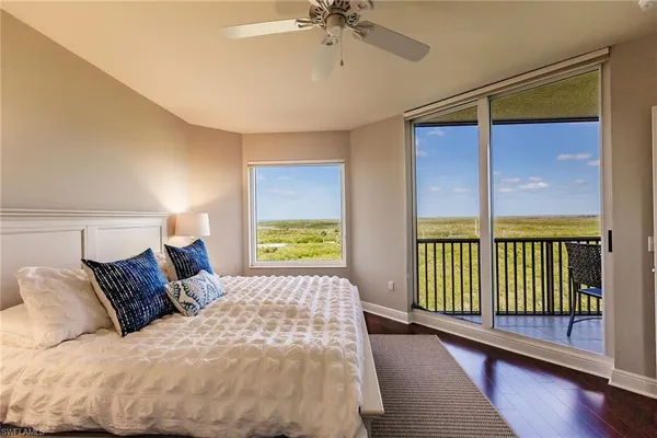 a bedroom with a balcony a bed and a window