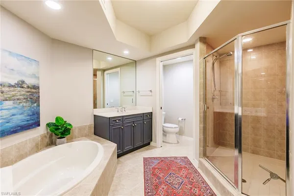 a spacious bathroom with a granite countertop tub sink and mirror